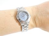 a woman ' s wrist that has a watch on it