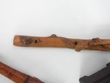 two different types of wood tools on a white surface