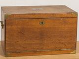 a small wooden box on a table with a key in it