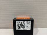 a close up of a small black and orange device on a white surface
