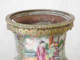 a vase with a painting on it sitting on a table
