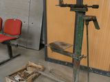 two red chairs in a room with a machine on the floor