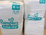 two packs of diapers sitting on top of each other on a table