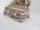 a white and gold bench with a painting on it