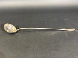 silver spoon with a spoon handle on a black surface