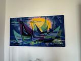 a painting hanging on the wall above a bed