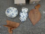 several pieces of pottery are sitting on the ground next to a cardboard box