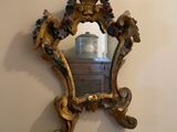 a mirror hanging on the wall next to a clock