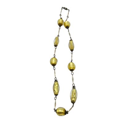 a long necklace with gold glass beads and a silver chain