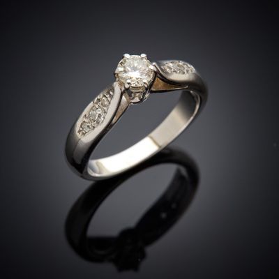 gros plan d'une bague en diamant sur une surface noire