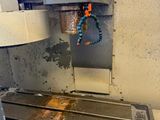 an image of a machine that is working on a piece of metal
