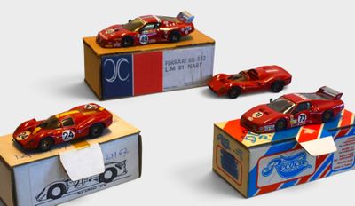three toy cars are sitting on top of a cardboard box