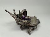 an image of a silver plate with a bird on top of it
