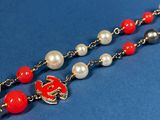 necklace with red and white pearls and a gold clasp