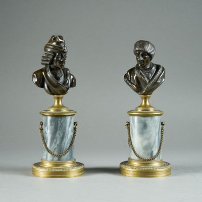 pair of bronze busts of a man and a woman on marble bases