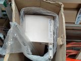 a box with a computer inside of it on the floor