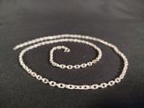 a close up of a necklace and bracelet on a black surface