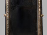 an antique black and gold mirror with a gold frame