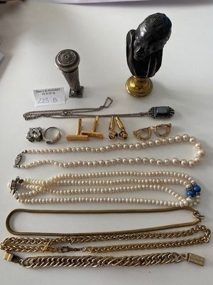 many different types of necklaces and bracelets laid out on a table