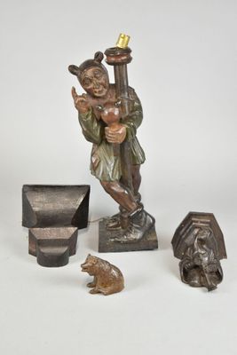 a statue of a man holding a lamp and other items