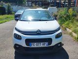 a small white car parked on the side of the road
