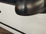 a close up of a side view mirror on a white car