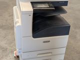 an office printer is sitting on top of a cart in a warehouse