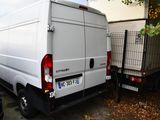 a white van that is parked next to a building