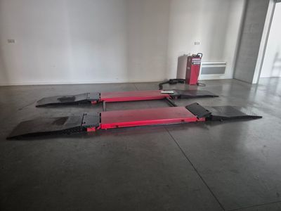 a red fire hydrant sitting on the floor next to a red fire hydrant