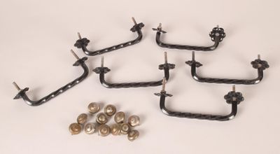 four pairs of metal hooks and screws on a white surface