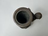 a small metal object that is on a white surface