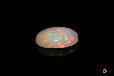 a white oplite in the dark with a black background