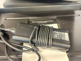 a laptop and a charger sitting on a desk