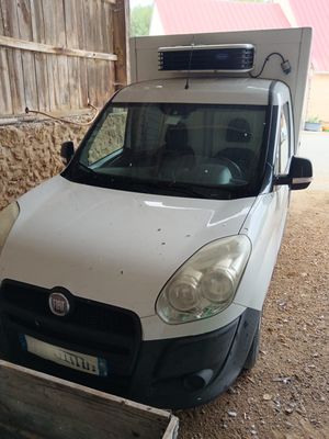 a white van that is parked in the dirt