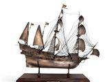 an image of a model of a ship on a wooden base