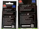 two packages of up batteries are sitting on a white surface
