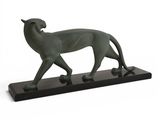 a bronze statue of a cat on a black base