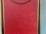 a red, blue, and yellow fire screen with chain hanging from it ' s sides
