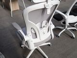 a white office chair with a computer monitor on top of it