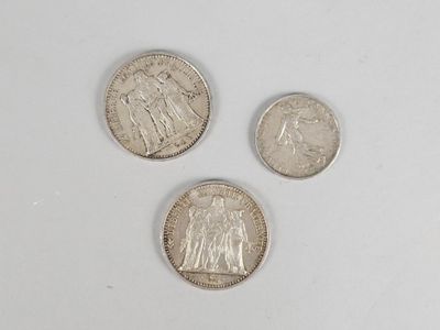 three different types of coins are shown on a white surface