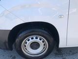 a white van that has a flat tire on the side of the road