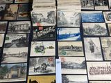 many old postcards are stacked on a table with a black background