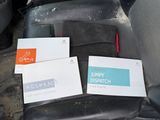 three business cards sitting on the seat of a car