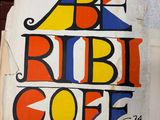 a sign that says be ribbi coffee on the side of a building