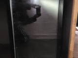 a man taking a picture of himself in the mirror of a refrigerator