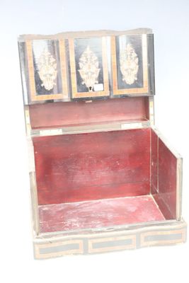 a small wooden box with a red interior sitting on a white surface
