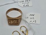 a gold ring and a pair of scissors next to a price tag