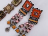 two pairs of bracelets and a bracelet with beads on a white surface