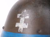 a close up of a helmet with a cross on it