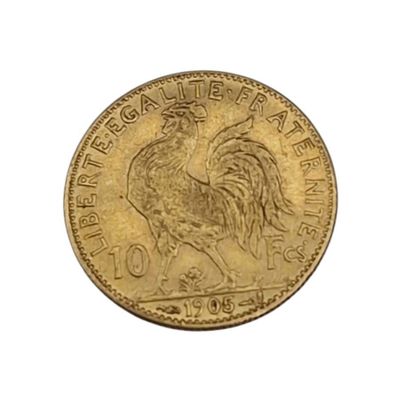 a close up of a gold coin with a rooster on it